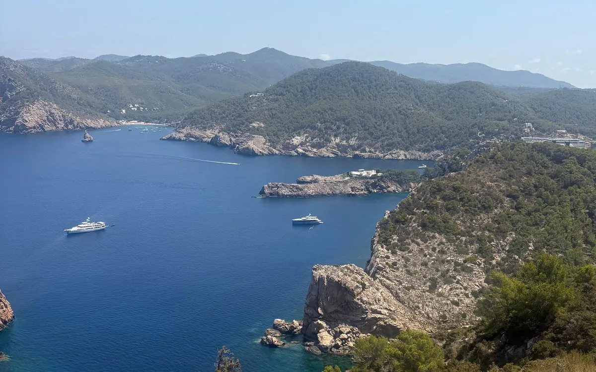 Wooded hills and a blue bay on the Ibiza coast seen from a viewpoint