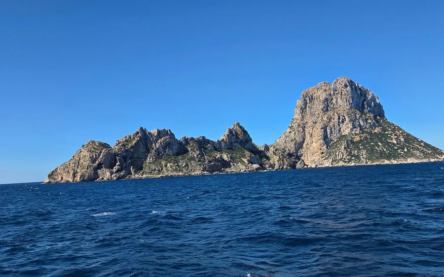 The rocky islet of Es Vedrà rising from a deep blue sea